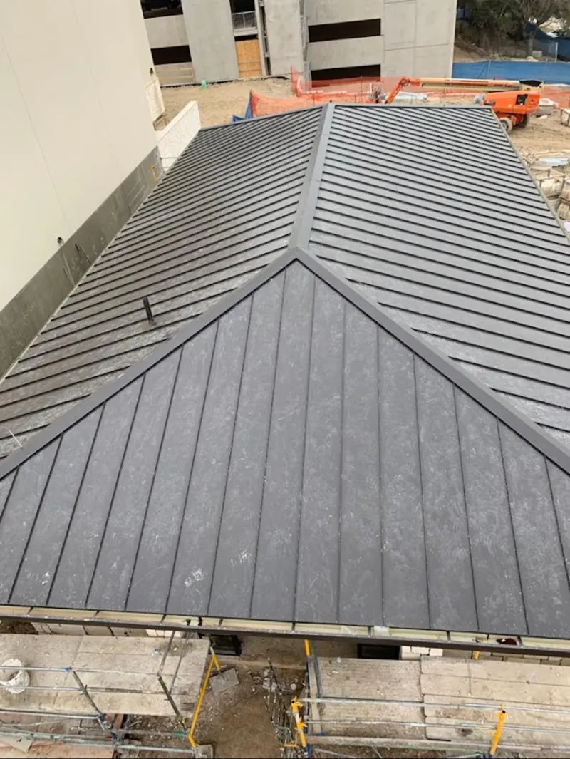 Commercial metal roof construction with crane equipment in Upper Mount Bethel